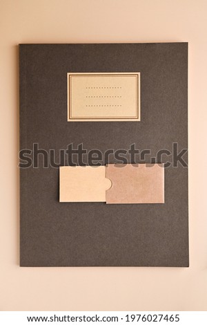 branding mockup with many craft paper and different subjects. Office desk with a paper notepad and a box of pencils. Contemporary workspace for men, minimalist style. Mockup. Copy space