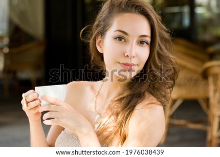 Gorgeous young brunette woman having coffee fun.
