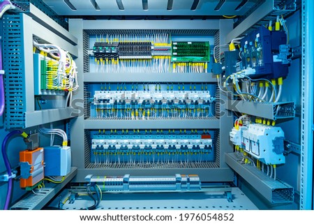 Switchboard equipment. Shield for enterprise automation. Concept - equipment for automation of equipment at enterprise. Panel with wires and switches at enterprise. Automation of production. Royalty-Free Stock Photo #1976054852