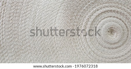 Top view of White cotton ribbon roll. Sturdy Tape for making, slings, straps, sewing clothes. Close up of A roll of white cloth that is wavy, the calm feeling of the Zen concept.