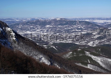 Winter view in the mountains with snow and sky. Forest and snowy fields in Stara planina, Bulgaria.