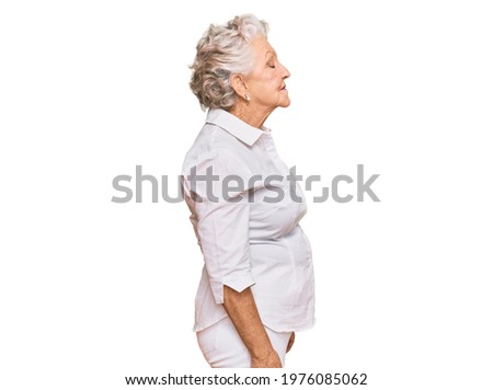 Senior grey-haired woman wearing casual clothes looking to side, relax profile pose with natural face with confident smile. 