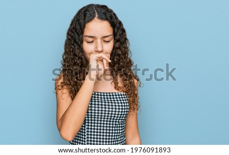 Teenager hispanic girl wearing casual clothes feeling unwell and coughing as symptom for cold or bronchitis. health care concept. 