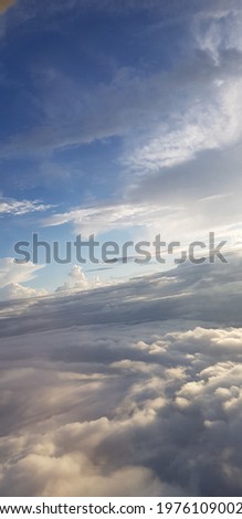 A picture of the above clouds taken from inside an airplane