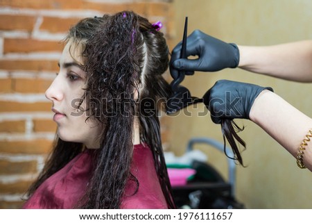 The process of straightening curly hair with keratin. Keratin hair straightening. Royalty-Free Stock Photo #1976111657
