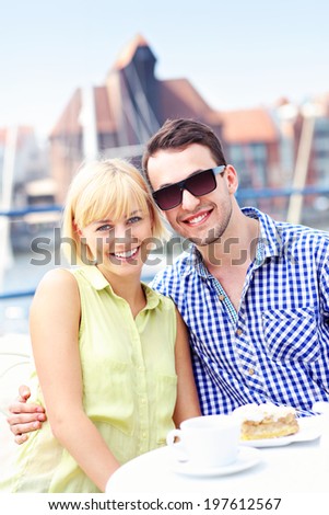 A picture of a young couple posing in a restaurant