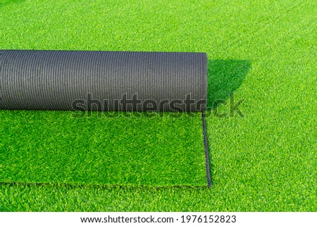 Roll of astroturf  or field turf matting of artificial grass soccer field,green lawn background. Royalty-Free Stock Photo #1976152823