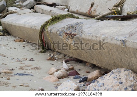 Cement pillars on the sandy beach were used to make a barrier.
