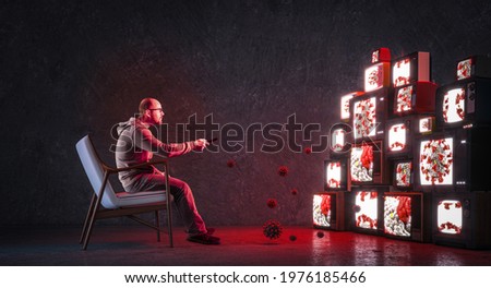 man on an armchair watching many televisions that only broadcast news about covid-19. Media health monopoly Royalty-Free Stock Photo #1976185466