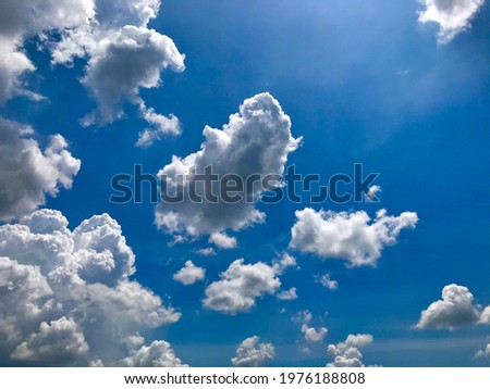Fluffy clouds in the clear sky Royalty-Free Stock Photo #1976188808