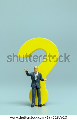 Miniature people ,Businessman with big question. workers trying to solve the problem concept