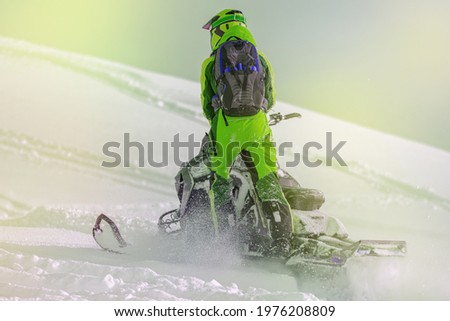 sports snowmobile in the mountains. super colored background with snowmobiles in the mountains. very high resolution photos for publications and advertising