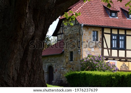 old half-timbered house with blooming lilac tree on the yard of Creuzburg castle