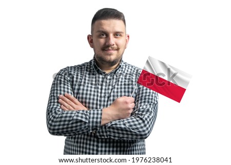 White guy holding a flag of Poland smiling confident with crossed arms isolated on a white background.