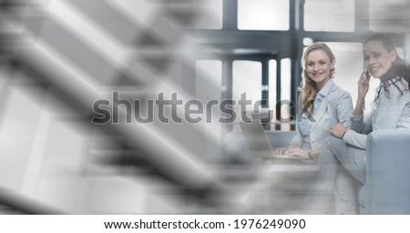 Composition of two smiling businesswomen working in office lounge with double exposure. global business, partnership and success concept digitally generated image.