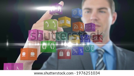 Composition of businessman touching screen with digital colouruful icons. global communication, technology and digital interface concept digitally generated image.
