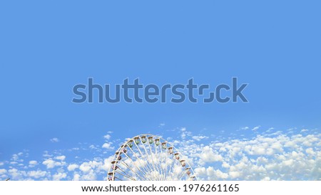 Banner of giant ferris wheel higher than clouds on blue sky background with copy space
