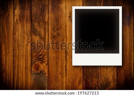 Photo frames on wooden board background texture