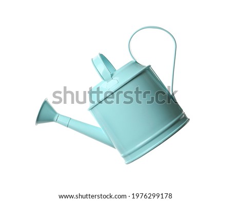 Turquoise metal watering can isolated on white Royalty-Free Stock Photo #1976299178