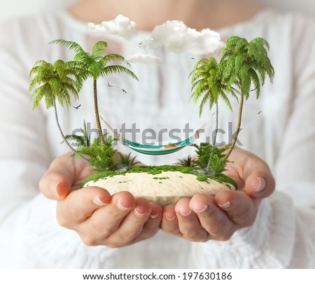Small fantastic island with a hammock and palms in women's hands.