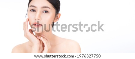 Closeup portrait of beauty asian woman with fair perfect healthy glow skin hand touching cheek isolated on white, young beautiful asia girl with pretty smile on face. Beauty korean spa skincare banner Royalty-Free Stock Photo #1976327750