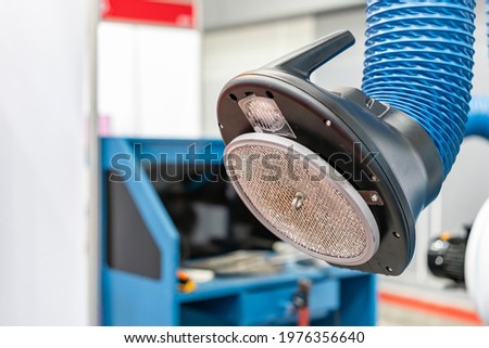 Industrial flexible tube hood and dust for suction smoke or fume of welding process or multipurpose use Royalty-Free Stock Photo #1976356640