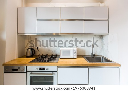 Interior photography luxury kitchen studio in loft style room in white, with kitchen furniture luxury
