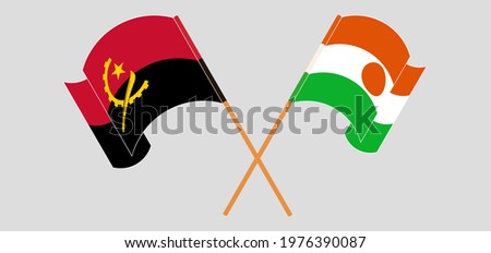 Crossed and waving flags of Angola and Niger