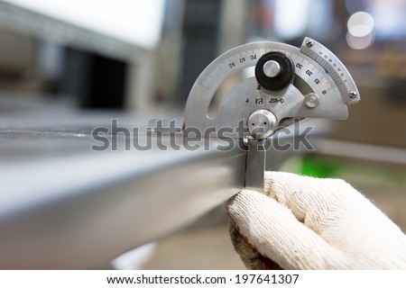 Industrial Worker Measure Detail with Protractor at Factory Workshop