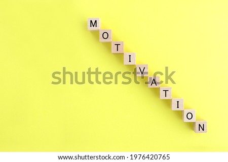 Downward graph composed by wooden blocks with motivation word