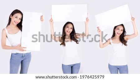 Asian woman show white board isolated on gray background.