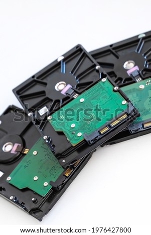 several hard drives for a computer for storing information on a white background, selective focus