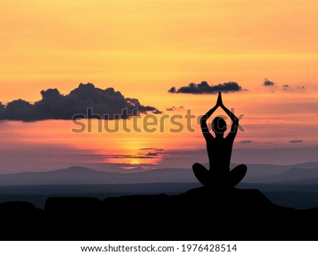 Woman practicing yoga on the mountain
