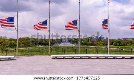 Panoramic view at Lincoln memorial behind the US flags from the ground of Washington monument. 