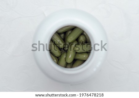 sport and diet concept - vitamins in a jar, top view
