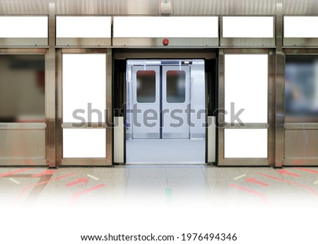 Mockup of blank poster advertising space in generic train station; OOH mock up. Straight front view of MRT platform, without people Royalty-Free Stock Photo #1976494346