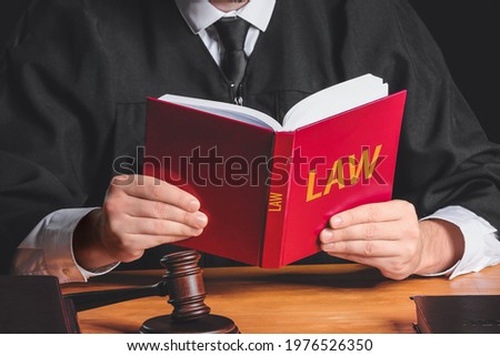 Male judge with book at table, closeup