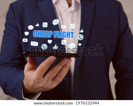  CHEAP FLIGHT text in search line. Businessman looking at smartphone. Cheapflights is a travel fare metasearch engine. 
