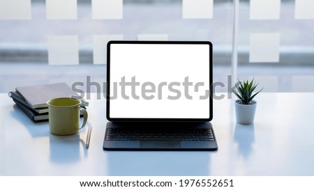 Tablet blank white screen place at the table.