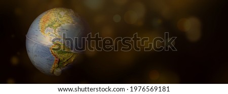 Planet earth in space. Staged photo. Golden bokeh
