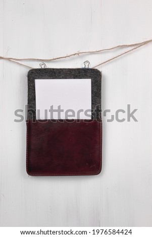 Clothes pin holding sheets of paper isolated over a white background