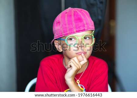 Emotional tan skin little boy grimacing with funny expression