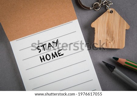Stay Home. Notebook on a gray office desk.