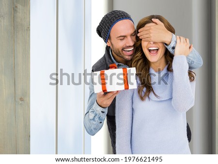 Man surprising his girlfriend with a gift and having smile. house background concept. digitally generated image