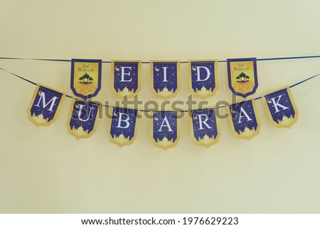 Label Eid Mubarak hanging on the wall