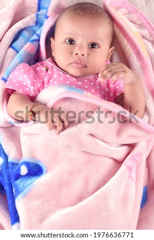 Two month baby wearing towel after bath. Childhood and baby care concept