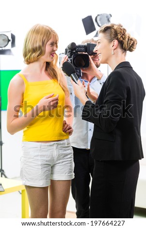 Reporter and cameraman film shoot actress interview on film set for TV or  Television 