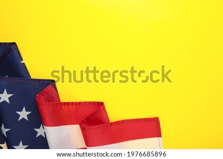 American flag on yellow background with copy space. Top view