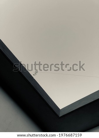 A upper wall design and blacl and white sky