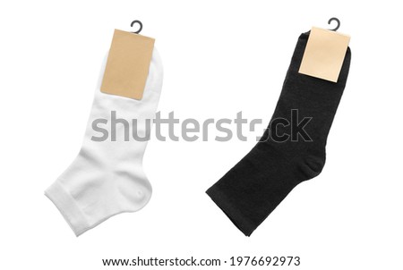 Pairs of cotton socks with blank labels on white background, collage 